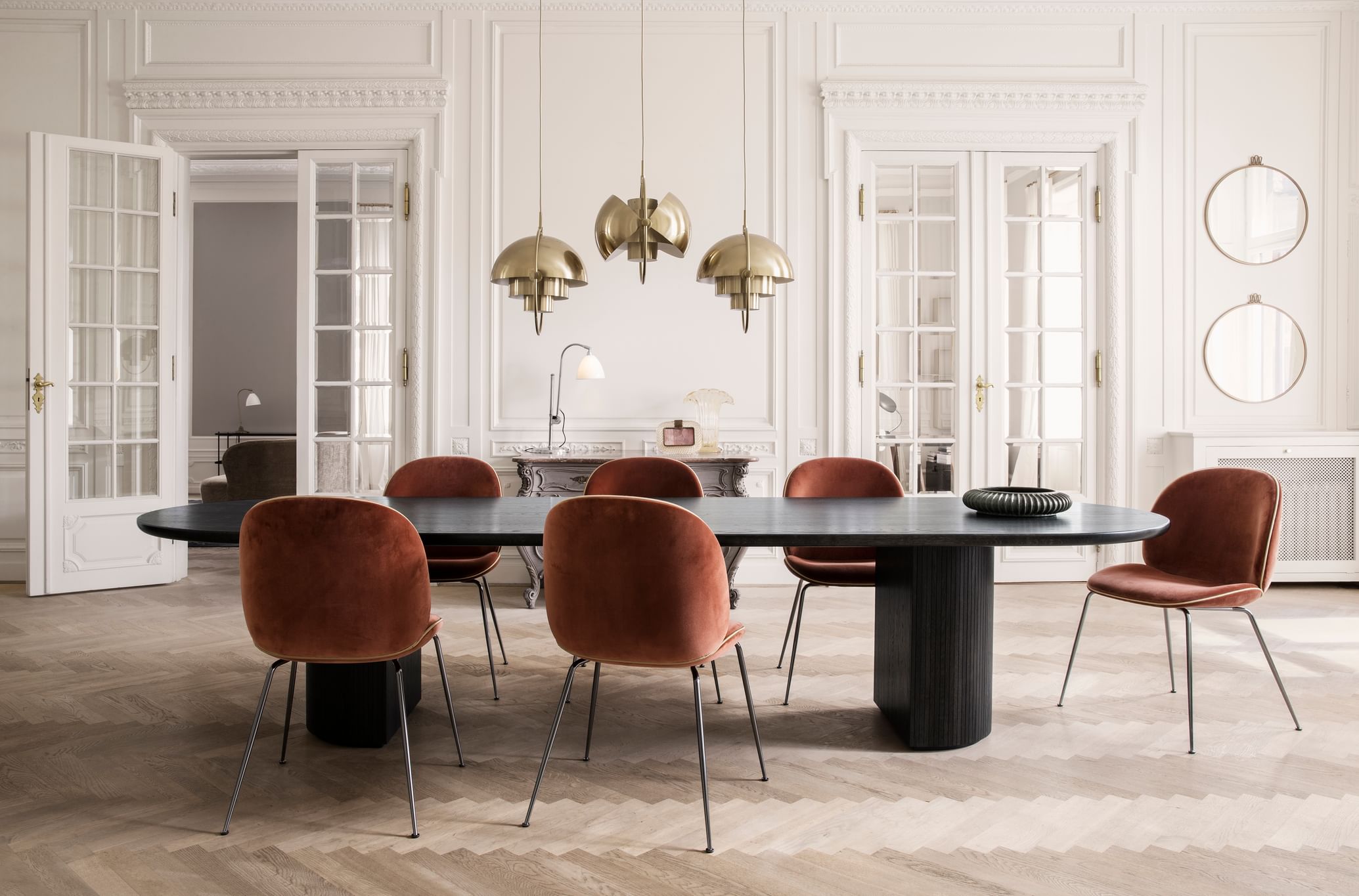 Designed by Space Copenhagen, the classic Moon Dining Table features an interplay between a beautiful solid oak table top and a smooth half or full moon shaped base with bevelled surface.