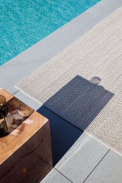 Limited edition rugs poolside rug pebblestone insitu haute living