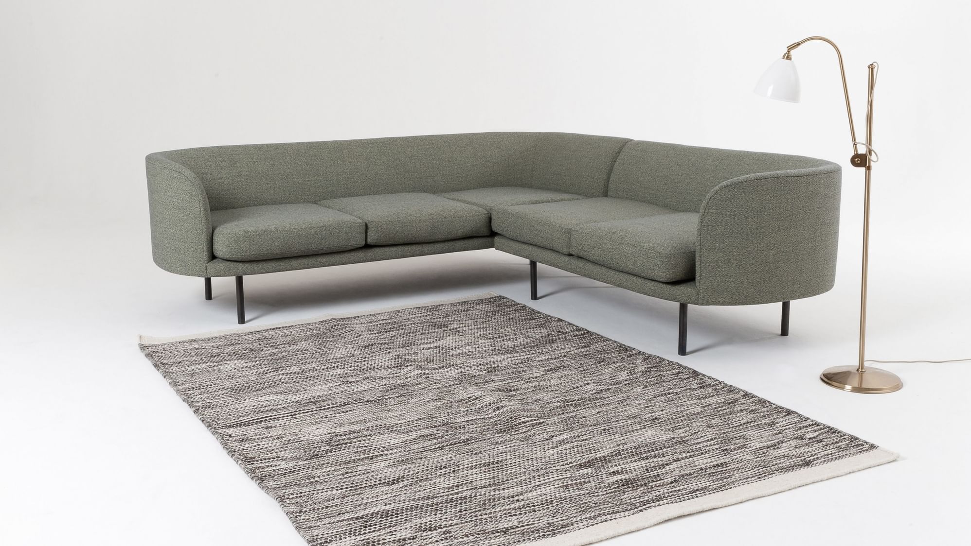Scp continous sectional sofa green rug haute living